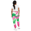 Pink and Green Swirl Warmup Pants Discover the ultimate workout and streetwear essential with our Pink and Green Swirl Warmup Pants! Made from a lightweight, water-resistant fabric and complete with a comfortable mesh lining, these pants are perfect for a